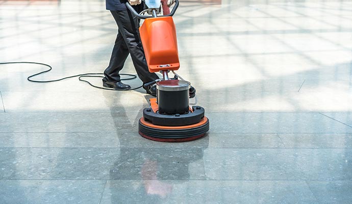 Person cleaning a commercial space floor